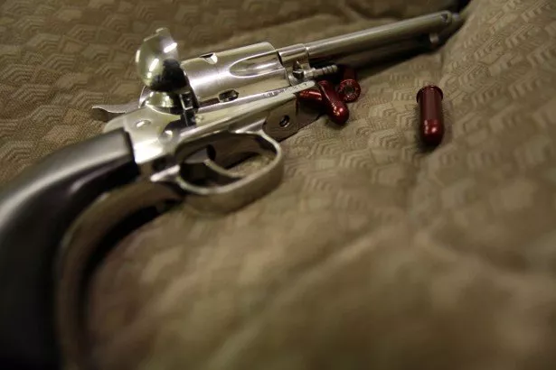 a revolver and dummy bullets are displayed on a case photo reuters a revolver and dummy bullets are displayed on a case photo reuters