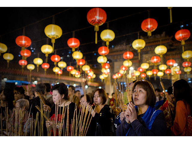 worshippers burn incense and pray at the wong tai sin temple to welcome the chinese new year of the horse on january 30 2014 photo afp