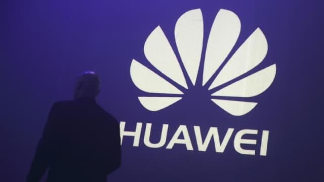 a man walks past a logo during the presentation the huawei 039 s new smartphone the ascend p7 launched by china 039 s huawei technologies in paris may 7 2014 photo reuters