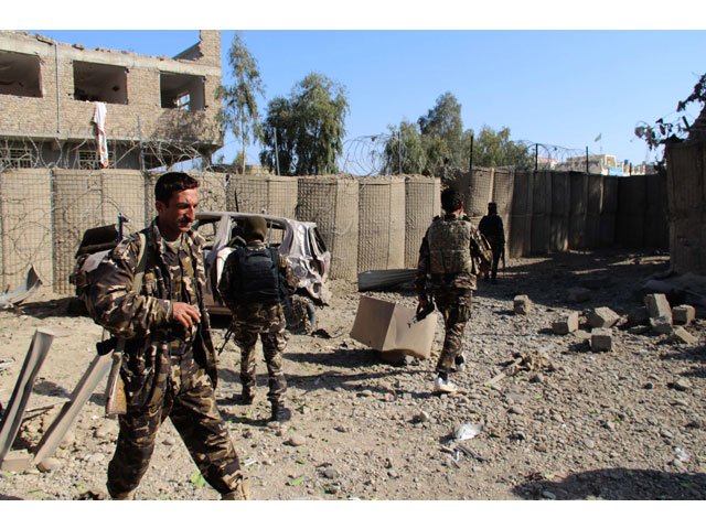 afghan security personnel inspect the site of a car bomb attack in lashkar gah capital of helmand province on february 24 2018 photo afp