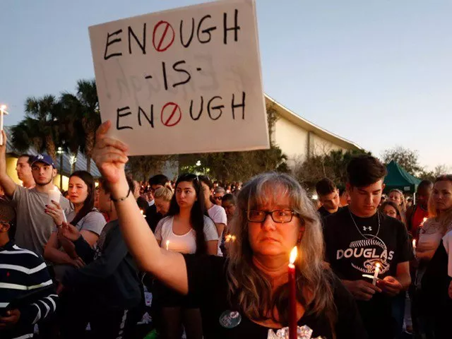 mourners stand during a candlelight vigil for the victims of marjory stoneman douglas high school shooting in parkland florida on february 15 2018 photo afp mourners stand during a candlelight vigil for the victims of marjory stoneman douglas high school shooting in parkland florida on february 15 2018 photo afp