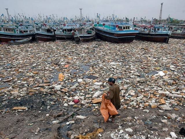 a boy looks for recyclable items in the polluted waters of karachi harbour pakistan photo reuters a boy looks for recyclable items in the polluted waters of karachi harbour pakistan photo reuters