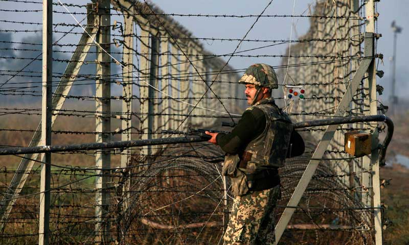 an indian border security force bsf soldier patrols near the fenced border with pakistan in suchetgarh southwest of jammu january 11 2013 photo reuters