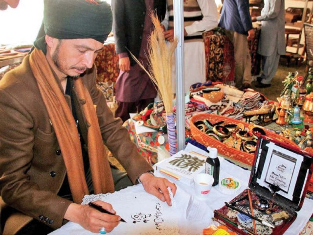 a calligrapher demonstrates skills during cultural caravan seminar held at pnca photo online a calligrapher demonstrates skills during cultural caravan seminar held at pnca photo online