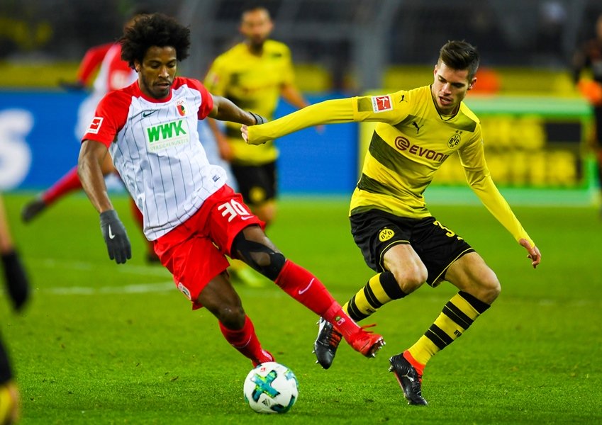 augsburg 039 s brazilian midfielder caiuby r and dortmund 039 s german midfielder julian weigl vie for the ball during the german first division bundesliga football match borussia dortmund vs fc augsburg in dortmund western germany on february 26 2018 photo afp