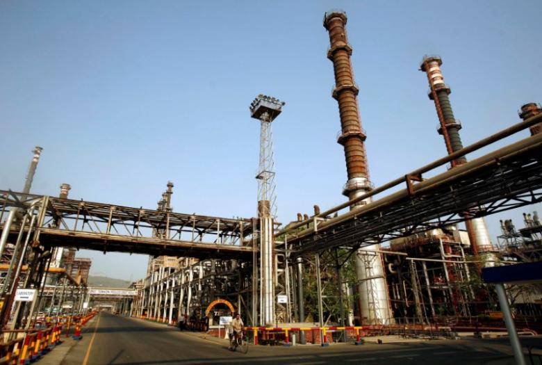 a worker rides a bicycle at a petroleum corporation photo reuters