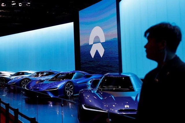 a man is silhouetted in front of nio cars at the auto show in shanghai china april 20 2017 photo reuters