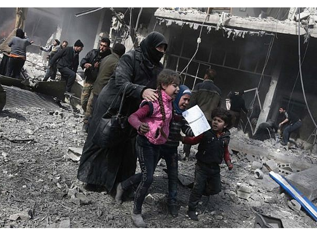 a syrian woman and children run for cover amid the rubble of buildings following government bombing photo afp a syrian woman and children run for cover amid the rubble of buildings following government bombing photo afp