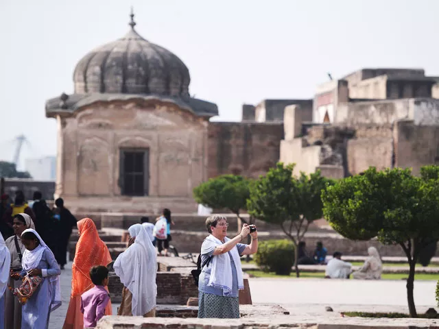 in this photograph taken on october 8 2017 tourists visit the historic mughal era lahore fort in the pakistani city of lahore perched on scaffolding restoration experts chip away at decades of grime and repair broken mosaic tiles that form collossal murals depicting battles and regal ceremonies on the walls of the iconic lahore fort afp photo aamir qureshi in this photograph taken on october 8 2017 tourists visit the historic mughal era lahore fort in the pakistani city of lahore perched on scaffolding restoration experts chip away at decades of grime and repair broken mosaic tiles that form collossal murals depicting battles and regal ceremonies on the walls of the iconic lahore fort afp photo aamir qureshi