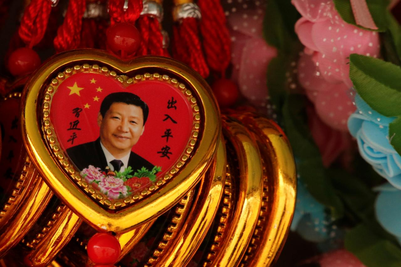 souvenir necklaces with a portrait of chinese president xi jinping are displayed for sale at a stall in tiananmen square in beijing china photo reuters