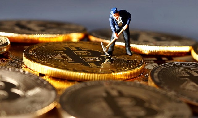 a small toy figure is seen on representations of the bitcoin virtual currency in this illustration picture december 26 2017 photo reuters