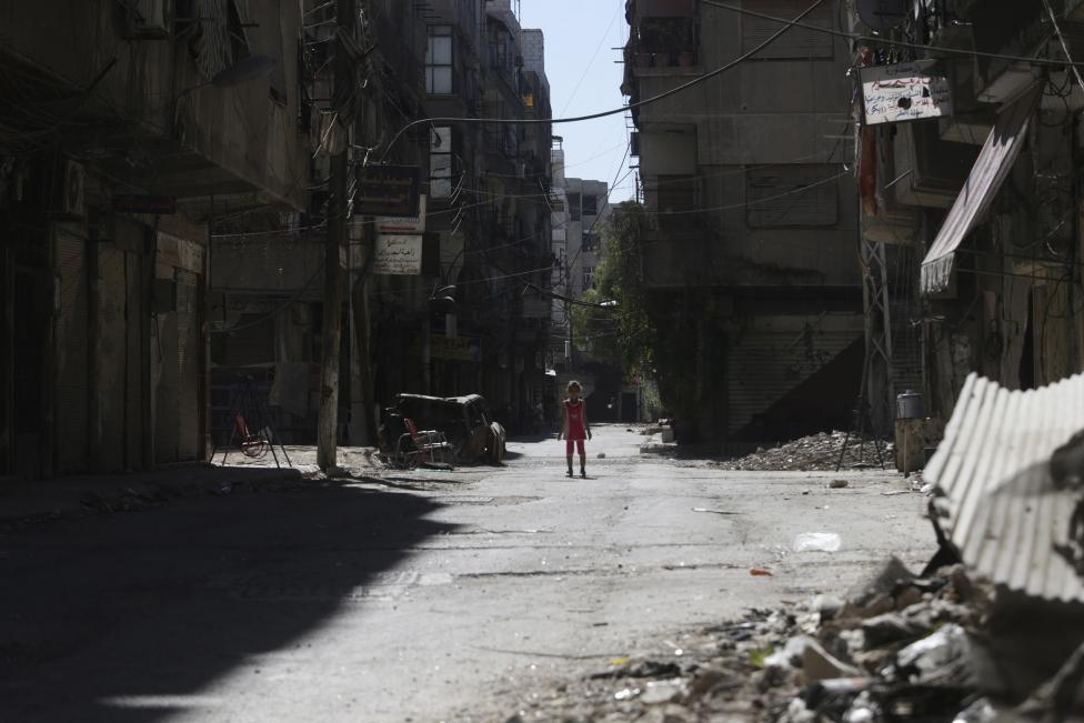 a girl stands in a damaged street in ain tarma in eastern ghouta a suburb of damascus photo reuters