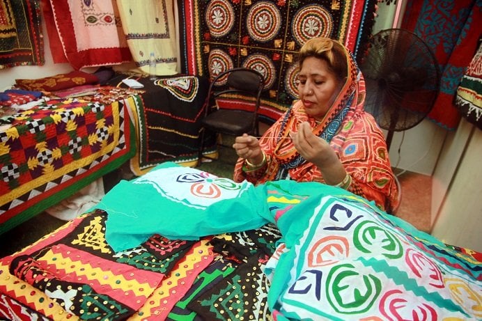 an artisan from sujawal sits at her stall in the sindh craft festival photo athar khan express
