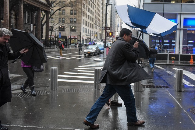 a person struggles with their umbrella during a large storm on march 2 2018 in new york new york a nor 039 easter is set to slam the east coast on friday bringing coastal flooding heavy snow and strong winds to the area photo afp