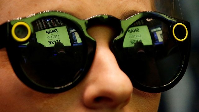 a woman wears snapchat spectacles on the floor of the new york stock exchange photo reuters