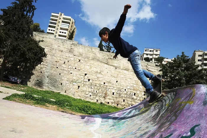 a refugee child skates on february 24 2018 at the quot 7hills skate park quot in amman that was constructed in 2014 by passionate skateboarding volunteers from all over the world thanks to an initiative launched by a german ngo and a local jordanian association which offers free skateboarding lessons to refugees several times a week some 140 refugee boys and girls from sudan somalia yemen iraq syria and palestine come every week to participate in the free lessons at the skate park afp photo khalil mazraawi