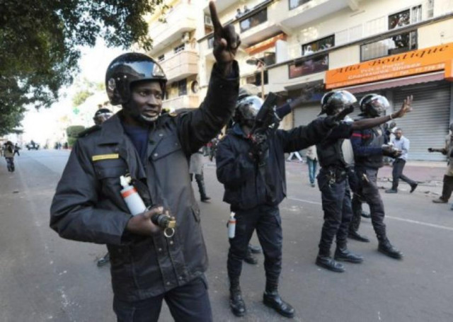 senegalese riot policemen prepare to launch tear gas canisters in dakar photo afp senegalese riot policemen prepare to launch tear gas canisters in dakar photo afp