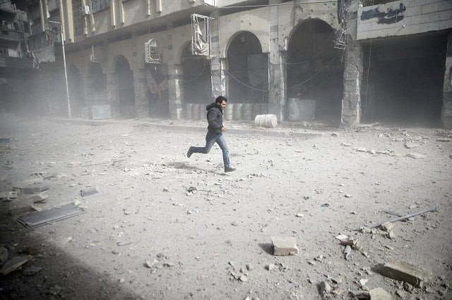 a man is seen running after an air raid in the besieged town of douma in eastern ghouta in damascus syria february 6 2018 photo reuters a man is seen running after an air raid in the besieged town of douma in eastern ghouta in damascus syria february 6 2018 photo reuters