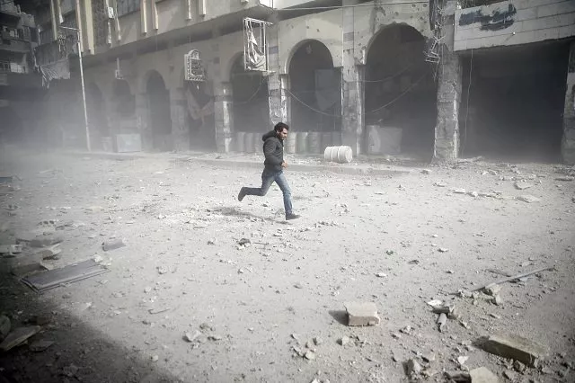 a man is seen running after an air raid in the besieged town of douma in eastern ghouta in damascus syria february 6 2018 photo reuters a man is seen running after an air raid in the besieged town of douma in eastern ghouta in damascus syria february 6 2018 photo reuters