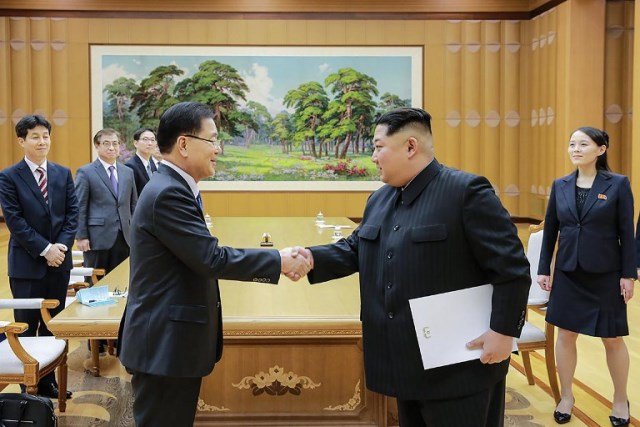 this handout from the presidential blue house taken on march 5 2018 shows north korean leader kim jong un r shaking hands with south korean chief delegator chung eui yong l who travelled as envoys of the south s president moon jae in during their meeting in pyongyang photo afp