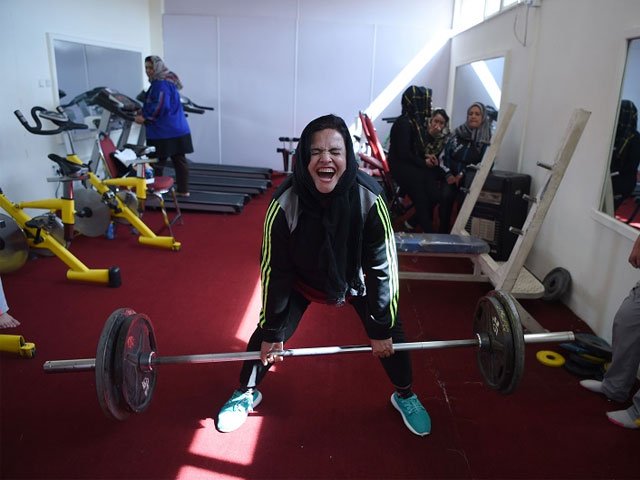 parhiz began powerlifting several years ago to help lose weight    she used to weigh 120kg and hid her ample body under a burqa photo afp