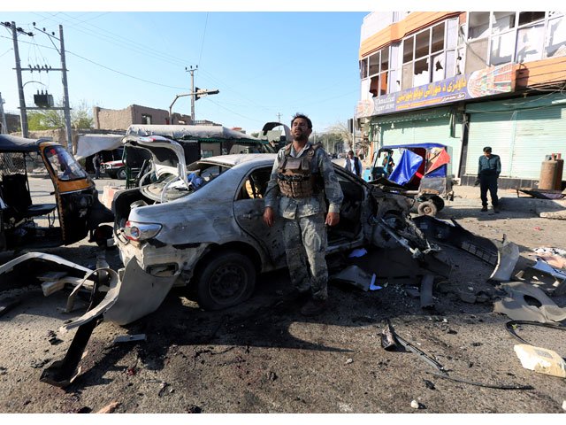 an afghan security forces member inspects at the site of a suicide attack in jalalabad afghanistan march 7 2018 photo reuters