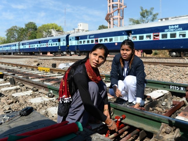 crew members work on a railway track at the gandhinagar railway station in jaipur photo afp