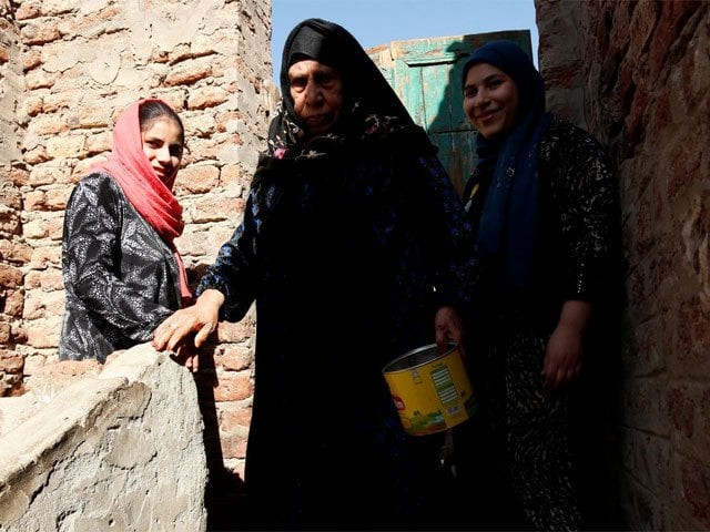 mageda c 80 walks with her granddaughters esraa salah r 15 and nada 14 at the rooftop of their home in alwasata village of assiut governorate south of cairo egypt february 8 2018 picture taken february 8 2018 photo reuters