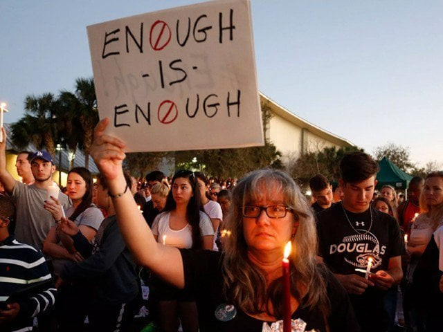 mourners stand during a candlelight vigil for the victims of marjory stoneman douglas high school shooting in parkland florida on february 15 2018 photo afp mourners stand during a candlelight vigil for the victims of marjory stoneman douglas high school shooting in parkland florida on february 15 2018 photo afp