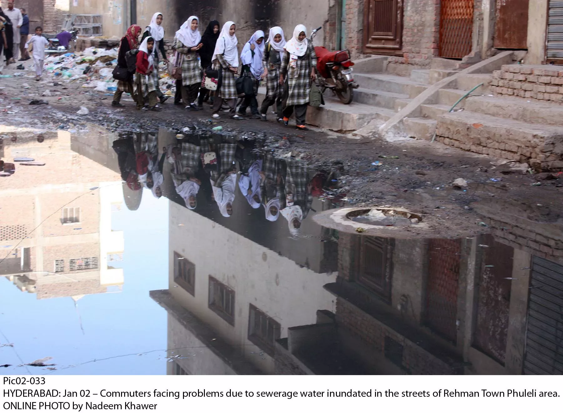 schoolgirls cross a sewage filled street in hyderabad 039 s rehman town photo online schoolgirls cross a sewage filled street in hyderabad 039 s rehman town photo online