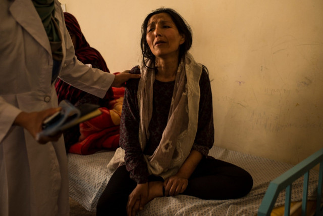 a woman recently admitted to the national center for the treatment of addiction for women and children in kabul is calmed by nurses and doctors after collapsing in a corridor during withdrawal from her opium addiction photo courtesy the washington post a woman recently admitted to the national center for the treatment of addiction for women and children in kabul is calmed by nurses and doctors after collapsing in a corridor during withdrawal from her opium addiction photo courtesy the washington post
