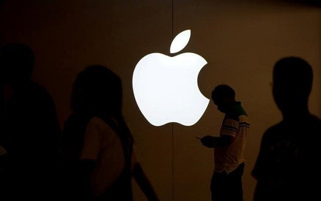 a man looks at the screen of his mobile phone in front of an apple logo outside its store in shanghai china on july 30 2017 photo reuters a man looks at the screen of his mobile phone in front of an apple logo outside its store in shanghai china on july 30 2017 photo reuters