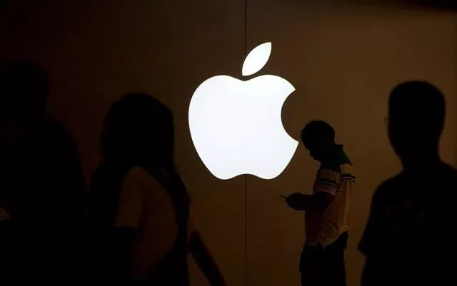 a man looks at the screen of his mobile phone in front of an apple logo outside its store in shanghai china on july 30 2017 photo reuters a man looks at the screen of his mobile phone in front of an apple logo outside its store in shanghai china on july 30 2017 photo reuters