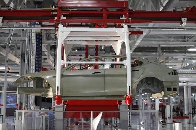 the body of a tesla model s is transported by an automated crane at the tesla factory in fremont california october 1 2011 photo reuters