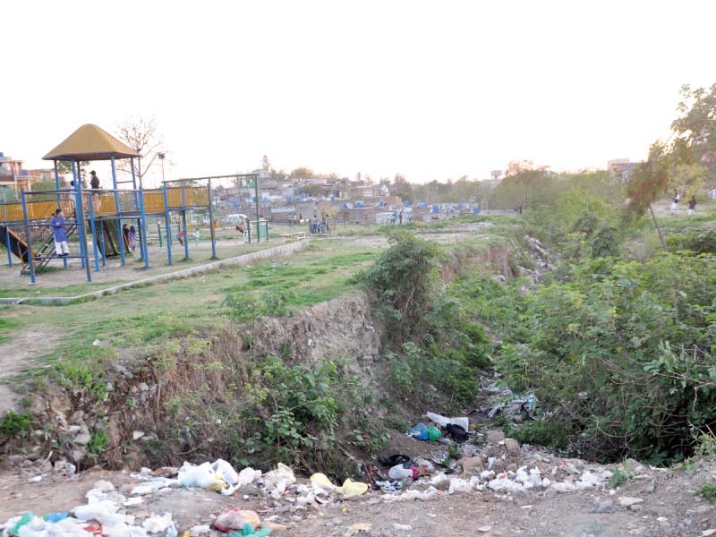 a view of sector g 7 children park where cda has put no grill or boundary along an open nullah photo zafar aslam