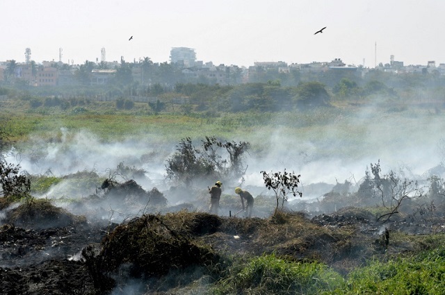 firefighters work at the polluted bellandur lake that has become so toxic it spontaneously catches fire photo afp