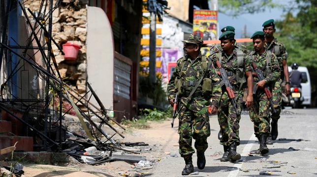 sri lanka 039 s special task force soldiers walk past a damaged houses after a clash between two communities in digana central district of kandy sri lanka march 8 2018 photo reuter photo reuters