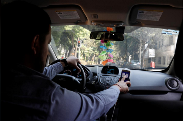 an uber driver checks the route on a mobile phone inside his car in mexico city mexico february 6 2018 picture taken on february 6 2018 photo reuters an uber driver checks the route on a mobile phone inside his car in mexico city mexico february 6 2018 picture taken on february 6 2018 photo reuters
