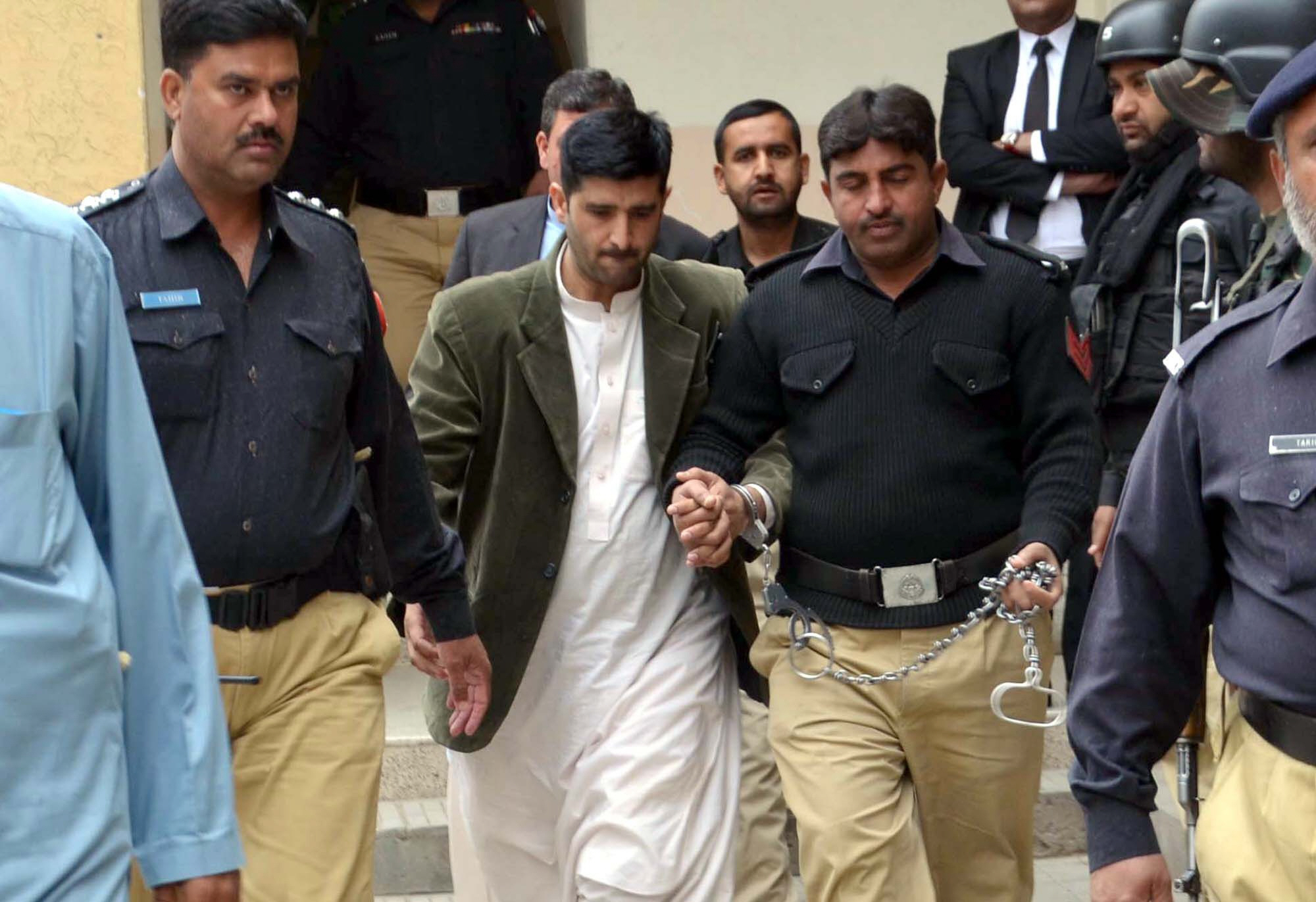 police personnel escort accused junaid shehzad out of the court premises photo express