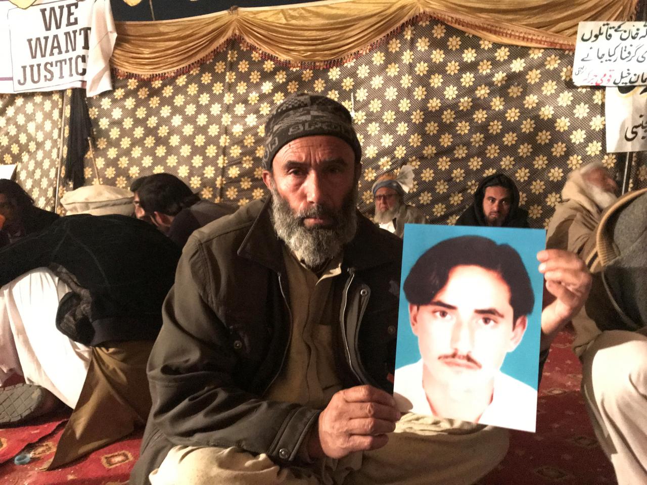 mohammad bilal holds a picture of his son hazratullah as he takes part in a protest with members of the pashtun community against what they say are enforced disappearances and routine oppression in islamabad photo reuters