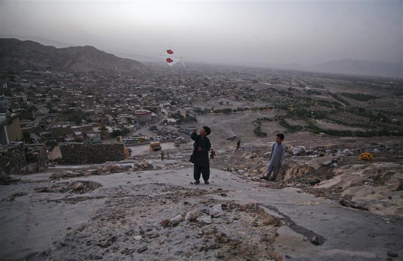 a boy from the hazara community flies a kite on a hilltop overlooking houses in mehrabad quetta on august 29 2012 photo reuters