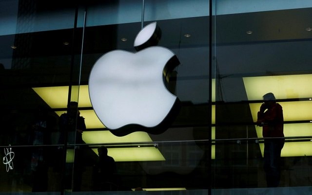 an apple logo is seen on the building 039 s facade as activists from the anti globalisation organisation attac hold the protest against alleged tax evasion by apple company in front of an apple store in frankfurt germany march 10 2018 photo reuters