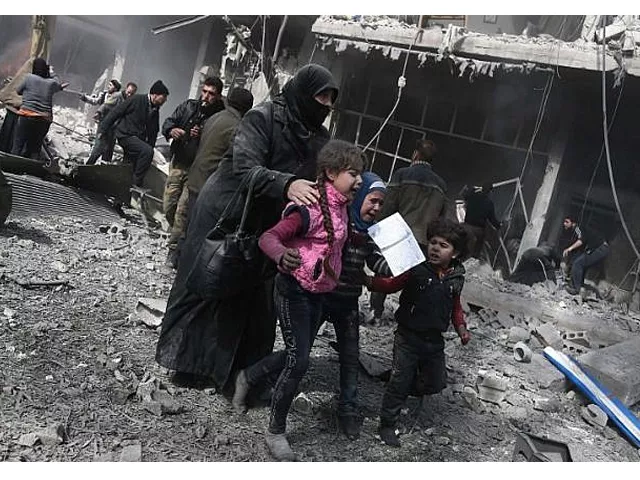 a syrian woman and children run for cover amid the rubble of buildings following government bombing photo afp a syrian woman and children run for cover amid the rubble of buildings following government bombing photo afp
