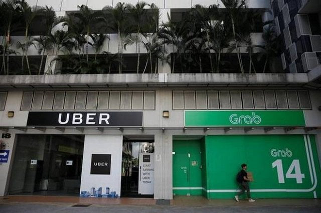 a comfortdelgro taxi passes uber and grab offices in singapore march 26 2018 photo reuters a comfortdelgro taxi passes uber and grab offices in singapore march 26 2018 photo reuters