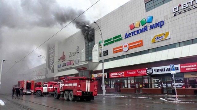 this handout picture released by the russian emergency situations ministry on march 25 2018 shows emergency vehicles as they gather outside a burning shopping centre in kemerovo photo afp