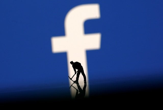 a figurine is seen in front of the facebook logo in this illustration taken march 20 2018 photo reuters