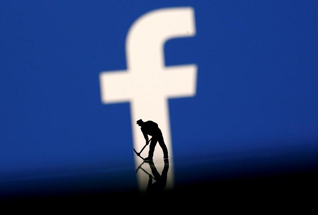 a figurine is seen in front of the facebook logo in this illustration taken march 20 2018 photo reuters