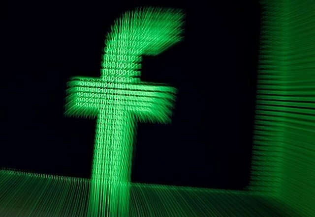 a 3d printed facebook logo are seen in front of displayed binary digits in this illustration taken march 18 2018 photo reuters