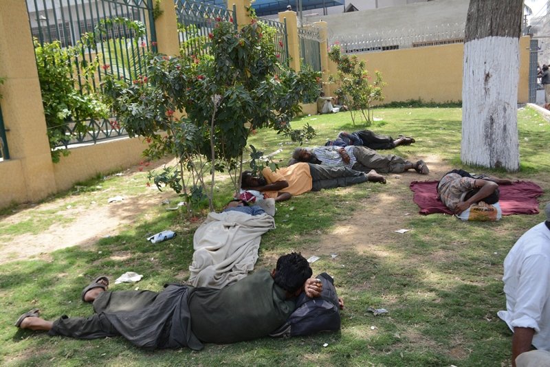 people lay about under a tree in karachi photo rashid ajmeri express