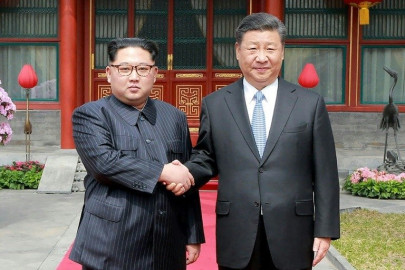 north korea s kim shows unity with china s xi in first foreign trip